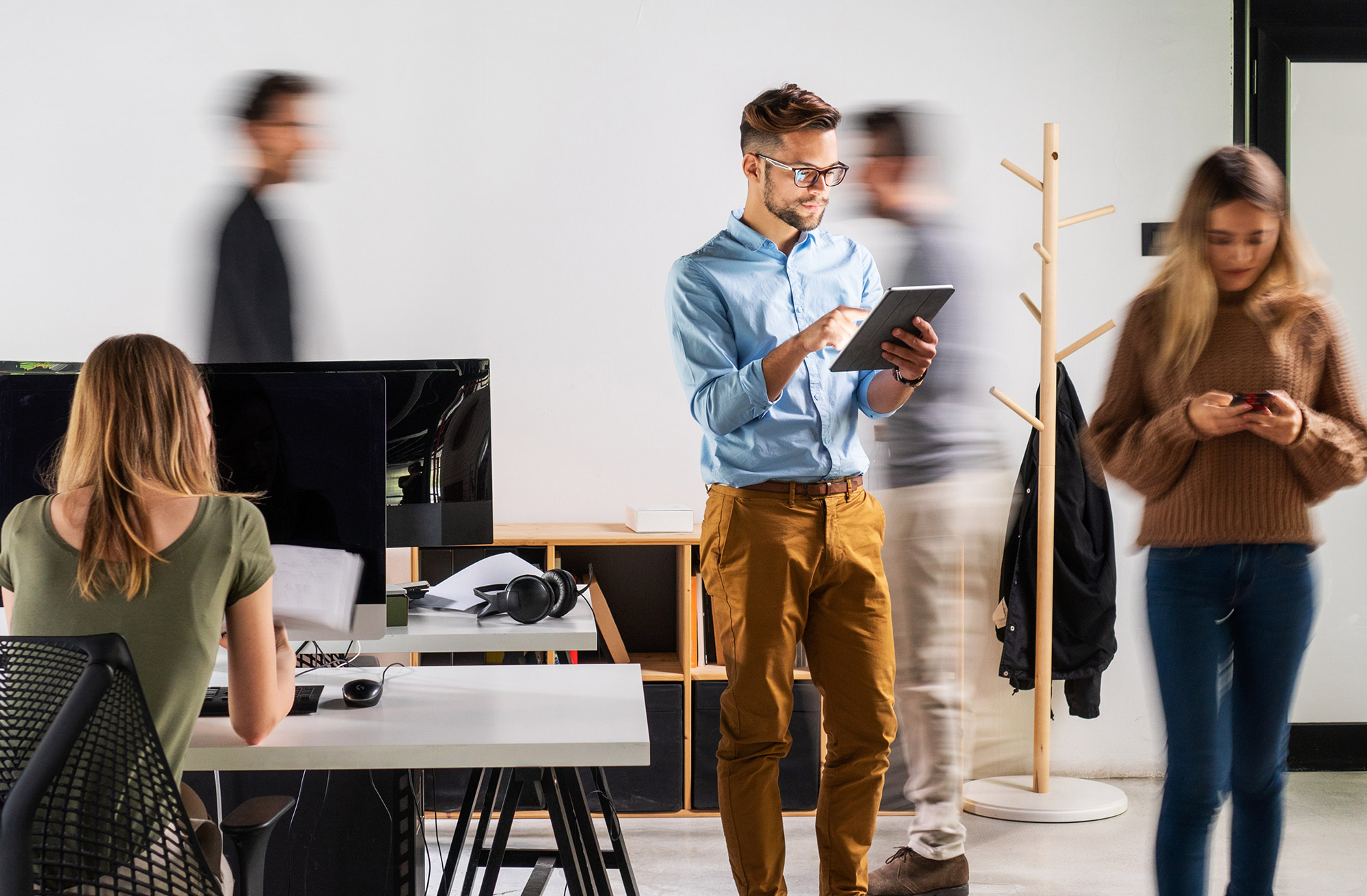 Personen stehen und sitzen in einem Büro
